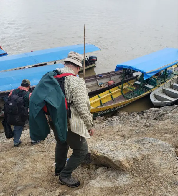 walking down a hill to board a boat in the river in Bolivia