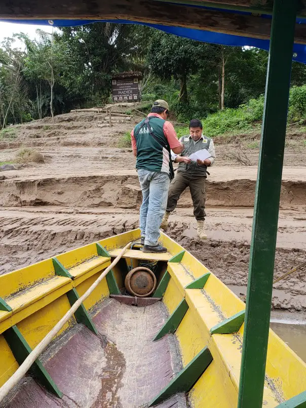 Madidi National Park Ranger collecting tickets on a canoe Bolivia