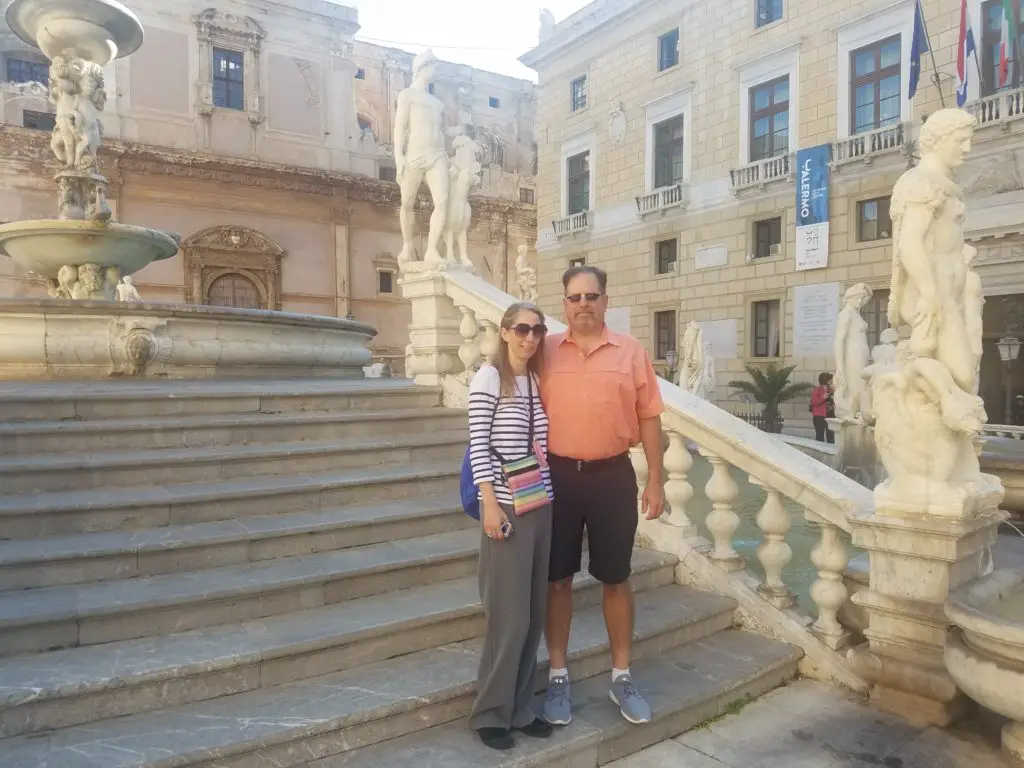 couple on the steps of a Sicilian fountain