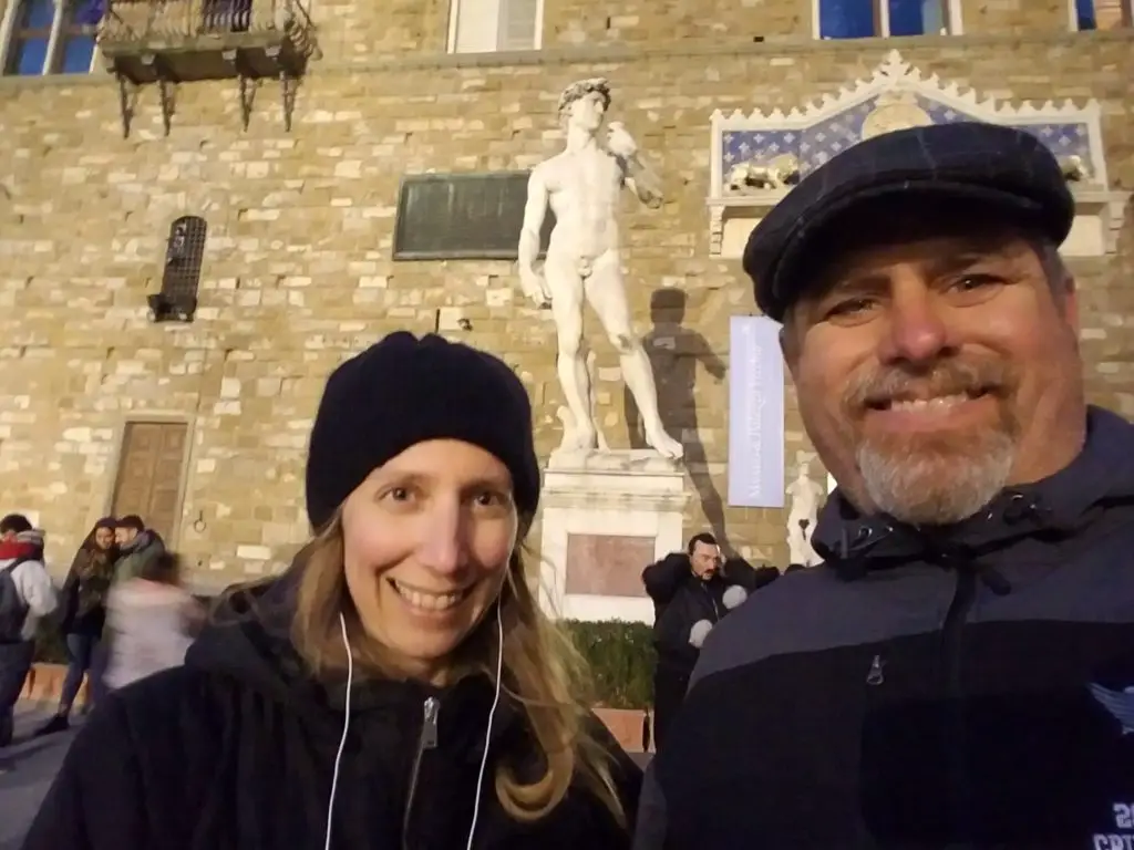 2 people in front of David statue