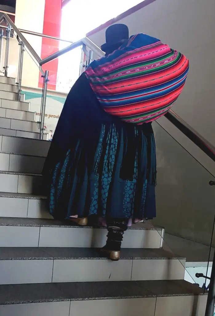 lady carrying large bundle up the stairs.