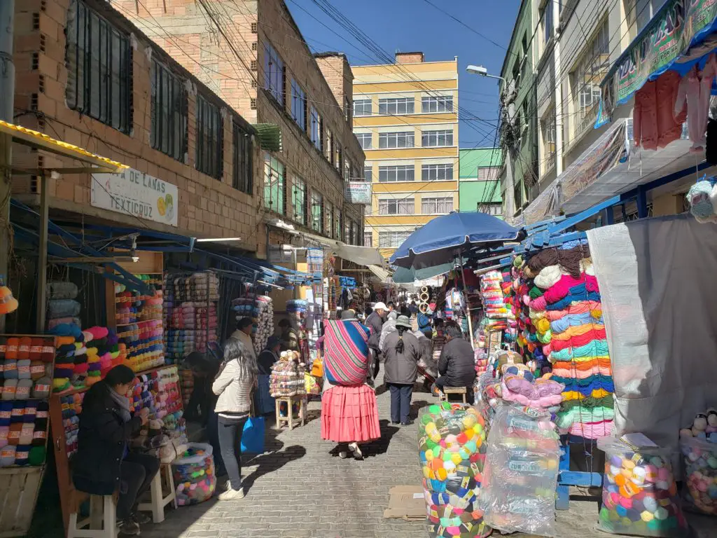 busy pedestrian street with colorful fabrics all around