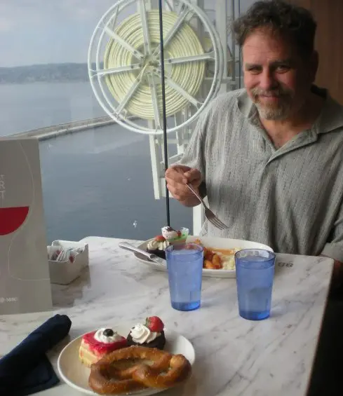 man enjoying Dessert on the top deck of MSC Meriviglia