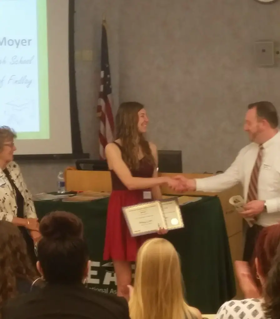 shaking hands after winning a scholarship from erie bank