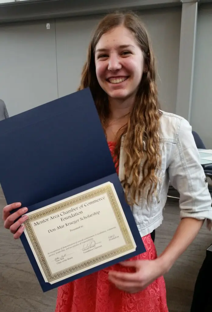 holding the chamber of commerce winning a scholarship