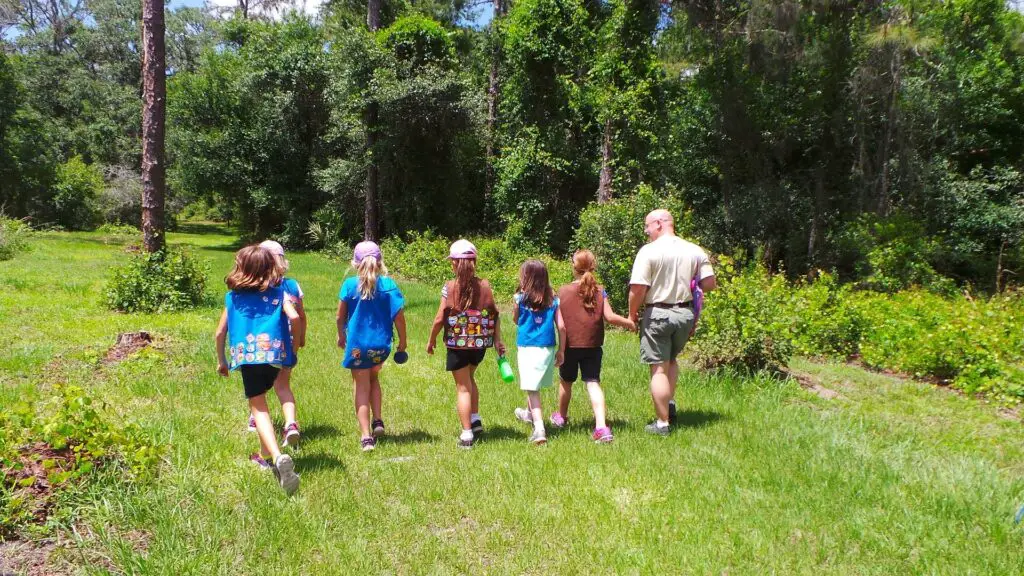 girl scouts walking in the grass