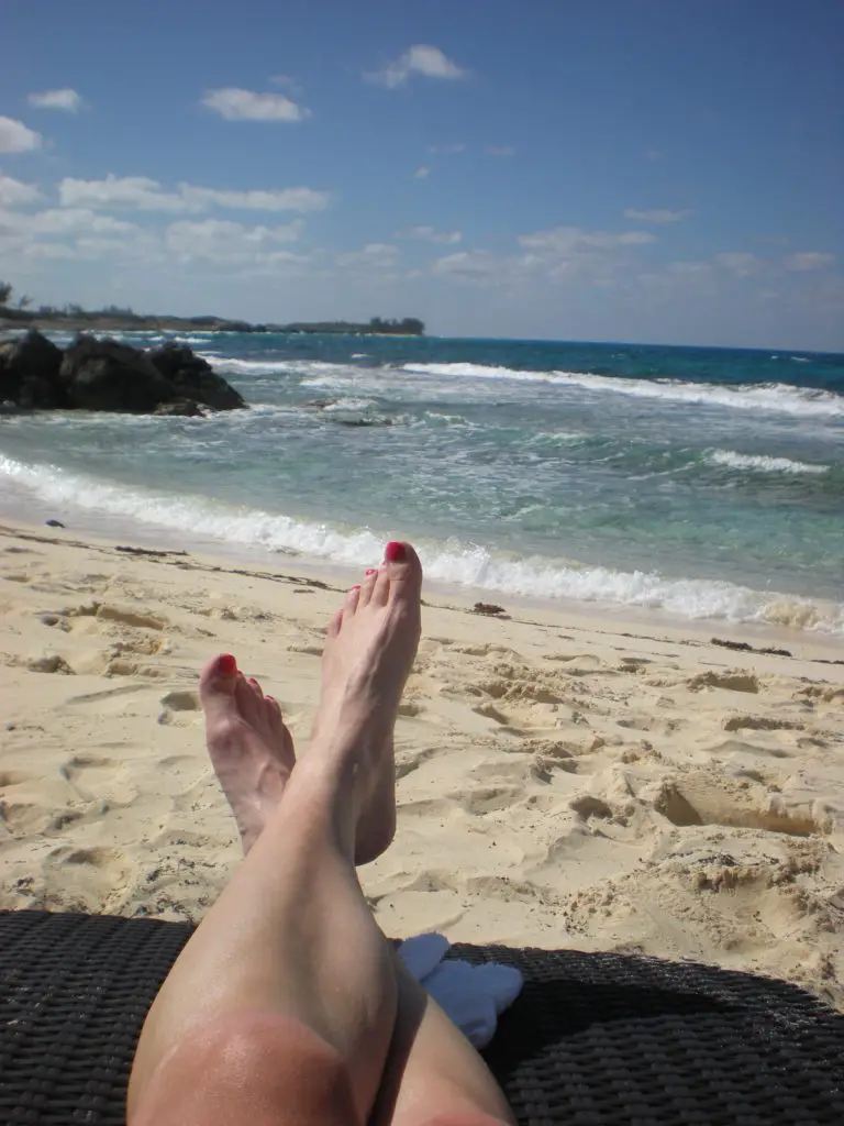 feet up and relaxing on the beach