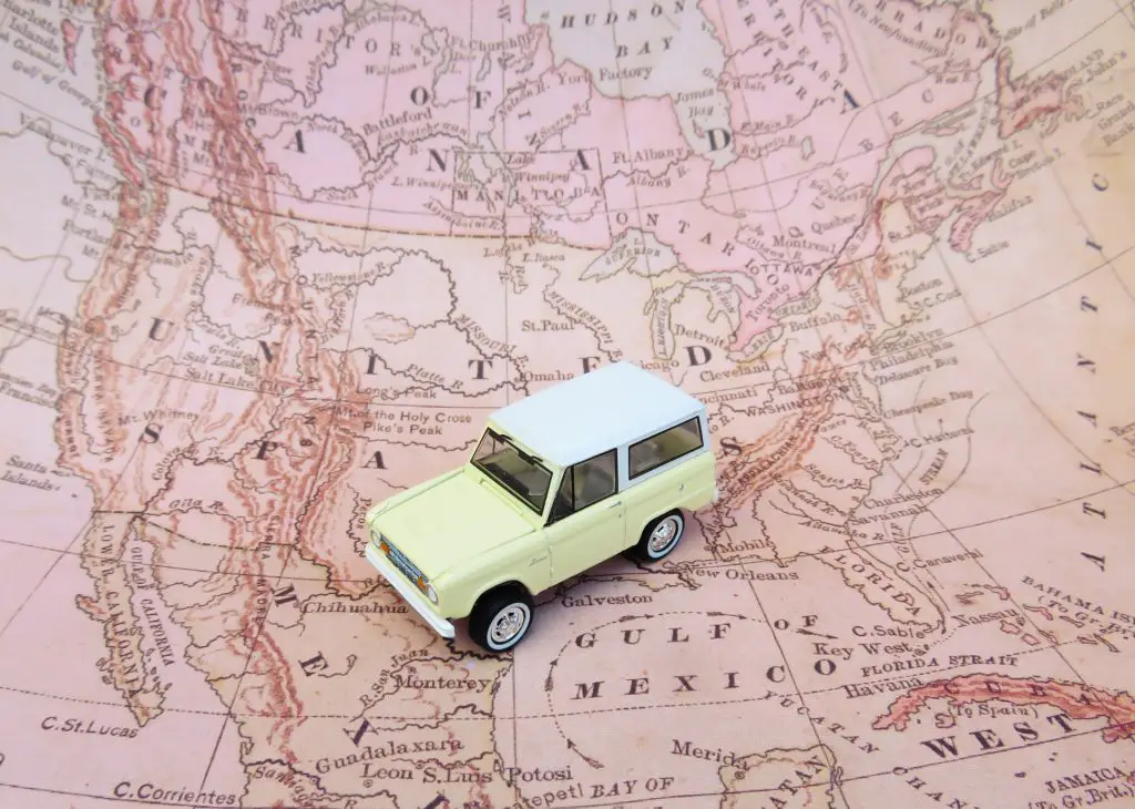 small toy car on top of map of North America