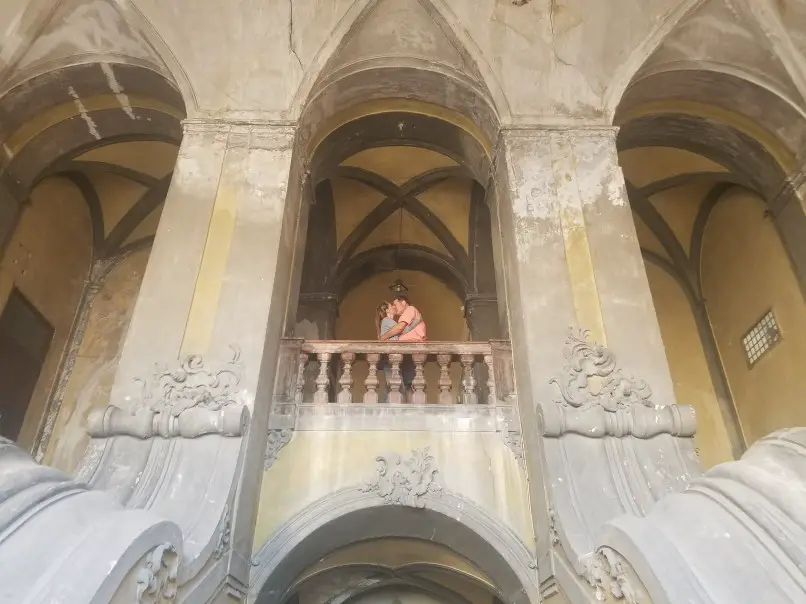 Kissing couple on a balcony in an old abandoned building in Palermo Sicily