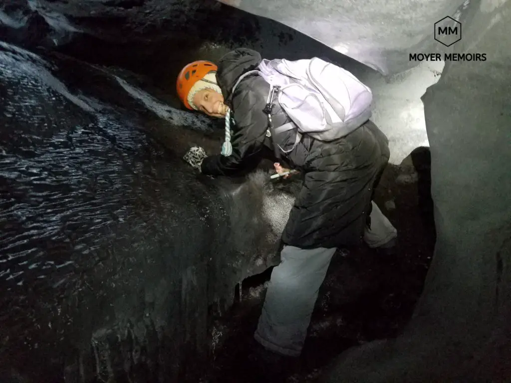 climbing through an ice cave in iceland