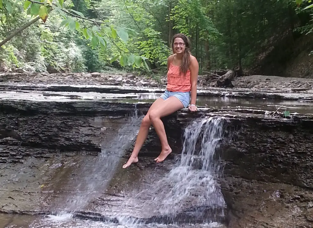 sitting in the creek at a waterfall