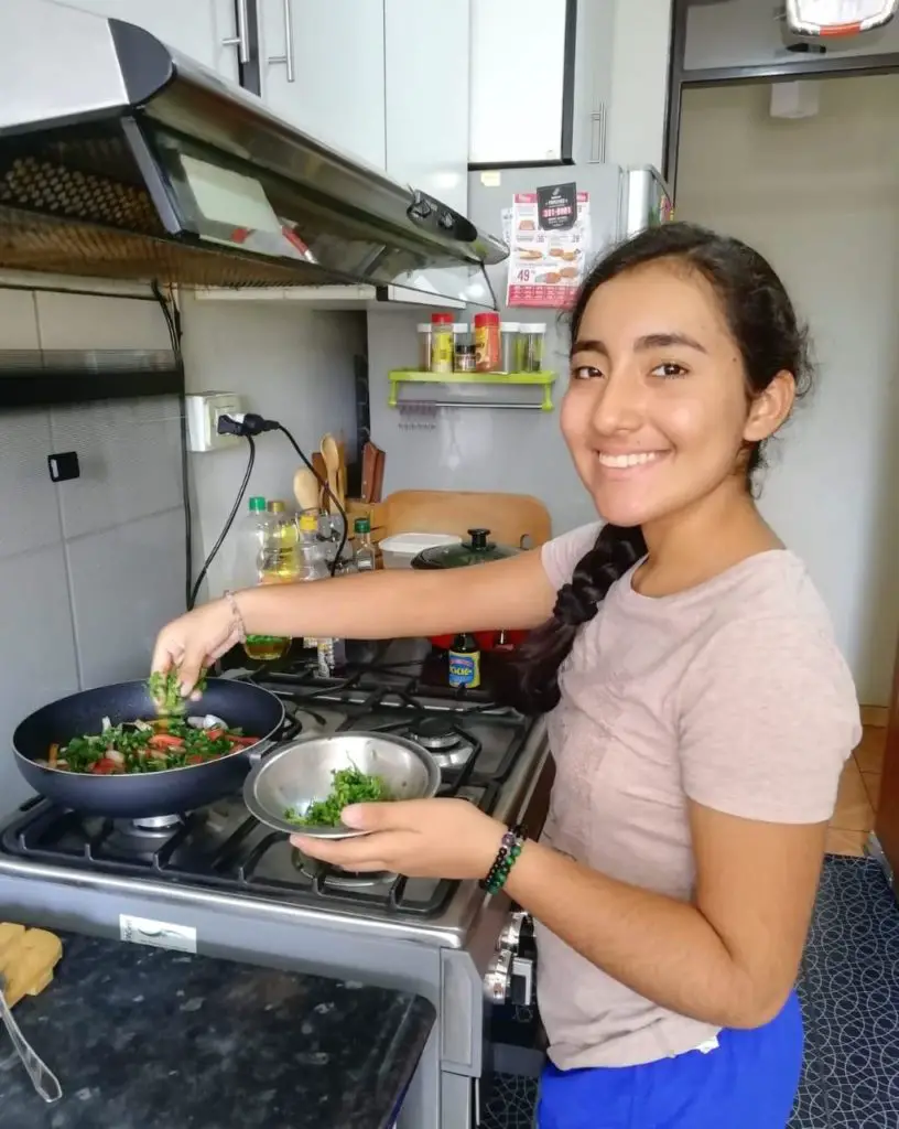 at the stove cooking