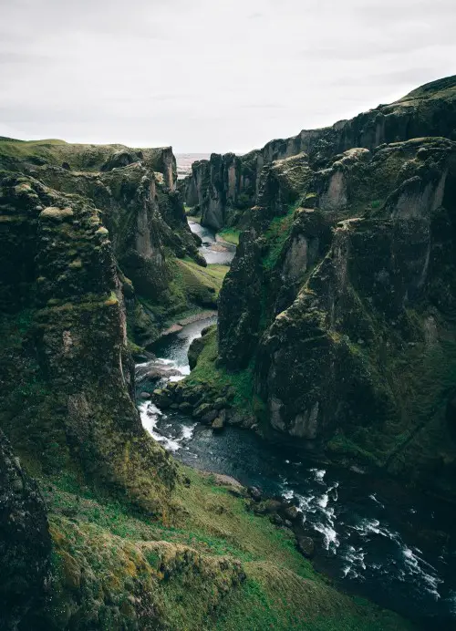 view of canyon with water running through it in Iceland