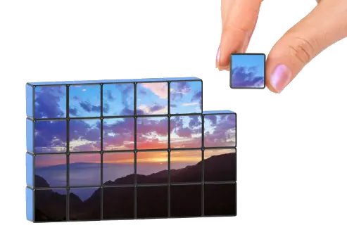 Hand putting together puzzle piece in a scenic photo puzzle