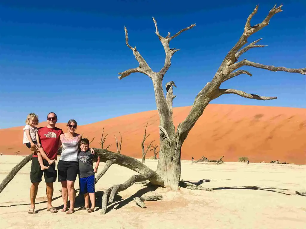 family in front of dunes in Africa