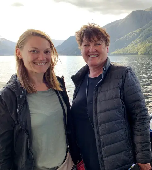 2 ladies in front of lake and mountains