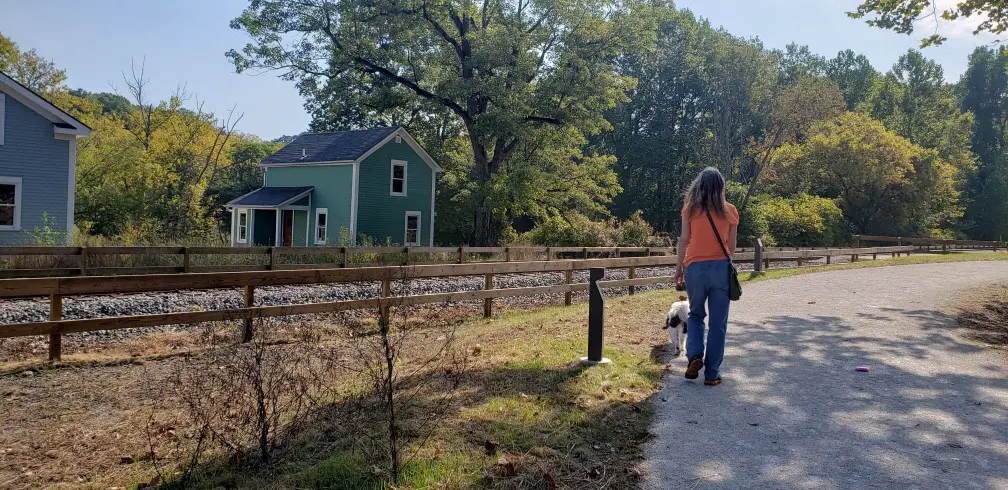 lady and walk walk on a path near railroad tracks at cuyahoga valley national park