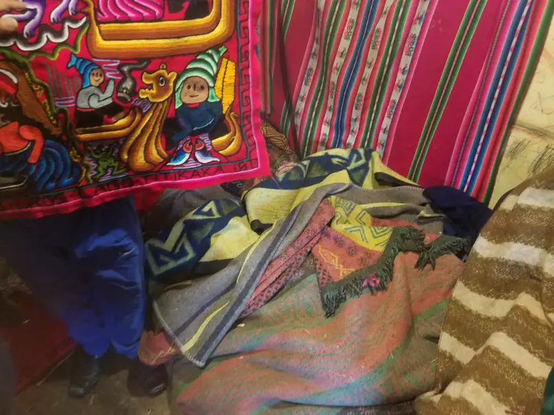 textiles displayed inside a uros hut