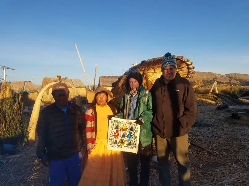 posing with a souvenir textile with Uros woman