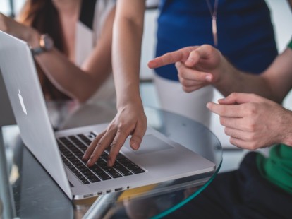 people in front of a computer for hosting a blog post collaboration