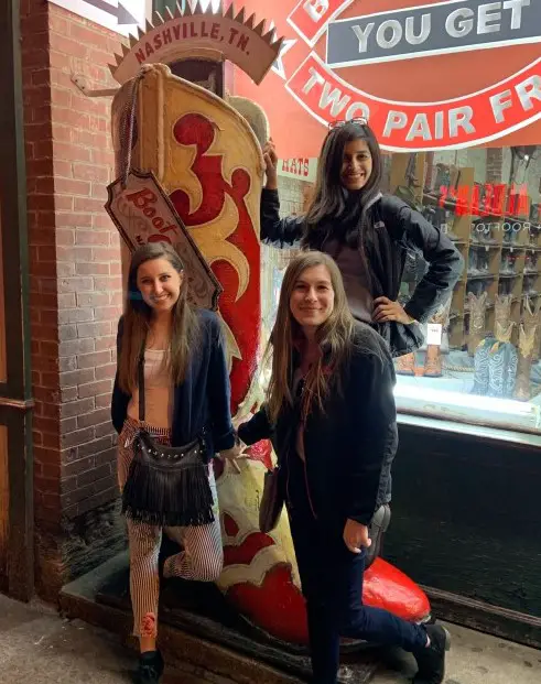 three girls posing by a boot in Nashville on a weekend trip