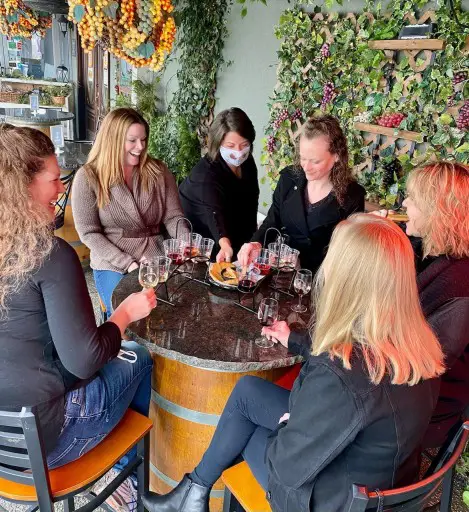 group gathered around a table on patio at Sumner Crest Winery on a weekend in Nashville