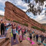 lots of people doing yoga at red rocks in Denver colorado
