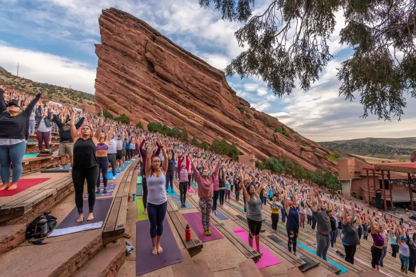 lots of people doing yoga at red rocks in Denver colorado