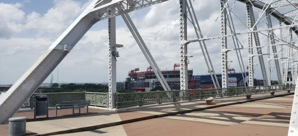 view of downtown nashville and stadium from pedestrian bridge over Cumberland River