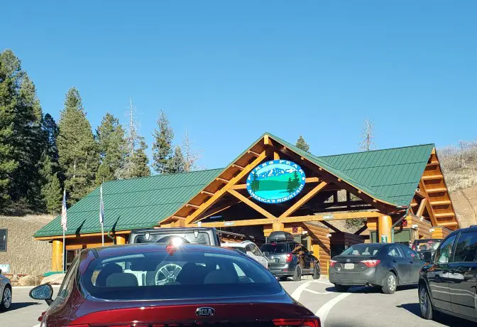 cars lined up in front of toll plaza entrance to pikes peak highway