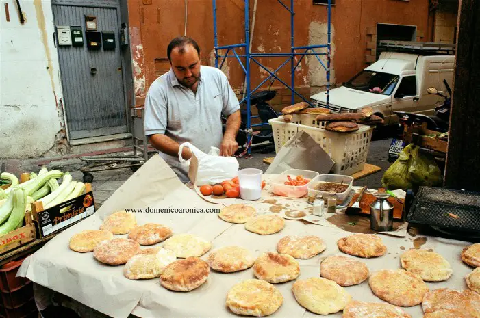 Man making Pane cunsato at Palermo street market in Sicily