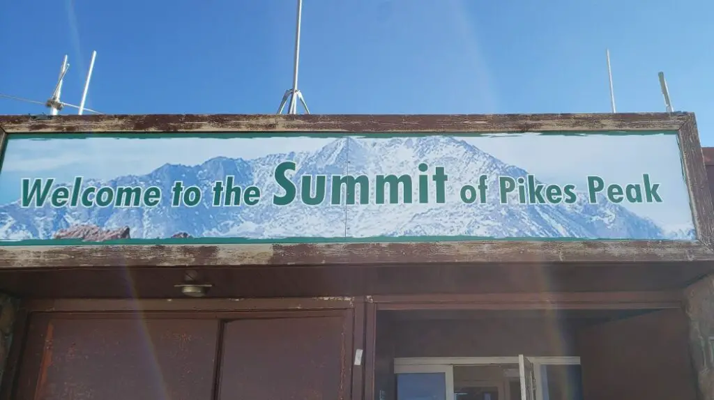 welcome to the summit of Pikes Peak Sign on the building after driving Pikes Peak