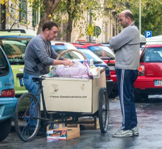 man at a cart - Vendor of frittola at the street market in Palermo Sicily