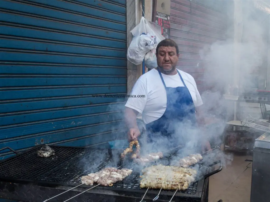 Man at a grill - Vendor of stigghiola at Palermo Street Food Market