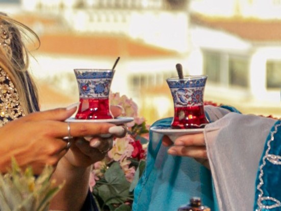 two hands holding Chai Turkish Tea in Turkey
