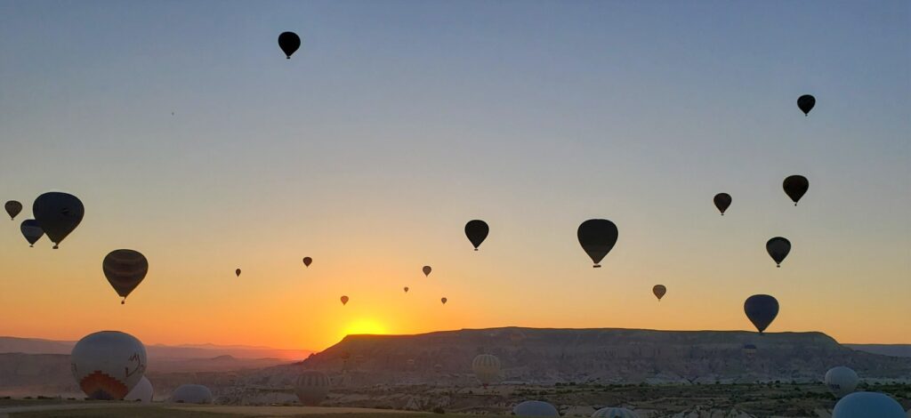 lots of Hot air balloons during sunrise in Cappadocia Turkey