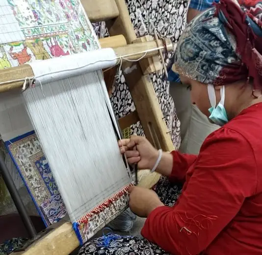 expert Weaving a Turkish Rug in anatolia at a turkish rug demonstation