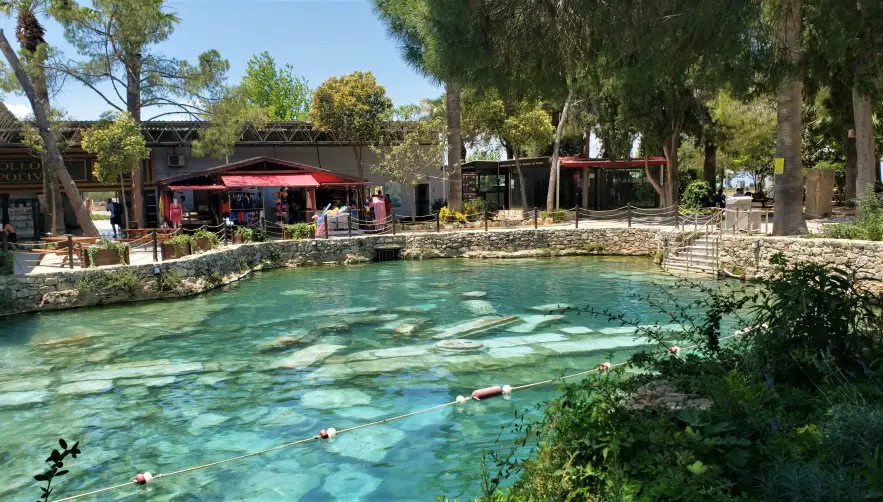 pool of crystal water and ancient pillars at Cleopatras Pool in Pamukkale in Turkey