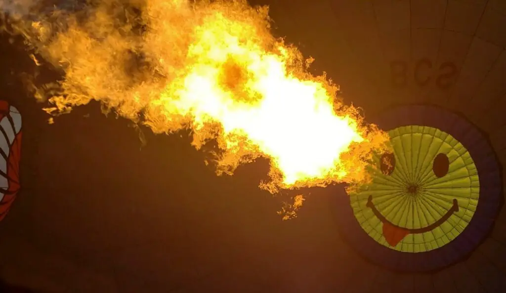 Fire heating up the cappadocia hot air balloon with smiley face on it