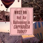 hot air ballons flying over scenery in Cappadocia Turkey