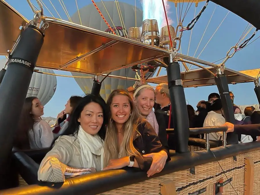 group posing in hot air balloon basket before cappadocia hot air balloon ride