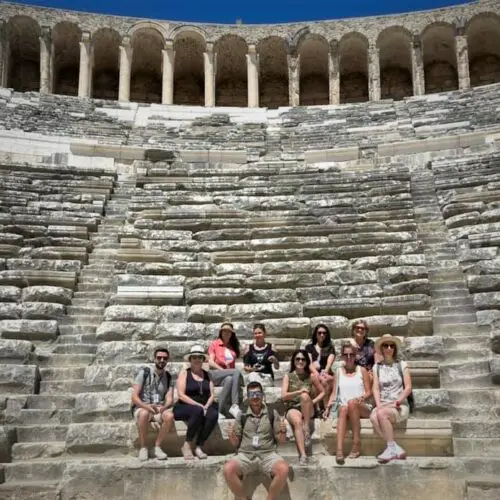 group sitting on seats at Aspendos Theater during one of the best small group tours in Turkey