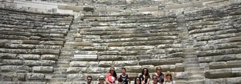 group sitting on seats at Aspendos Theater during one of the best small group tours in Turkey