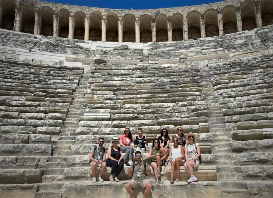 group sitting on seats at Aspendos Theater during one of the best small group tours in Turkey