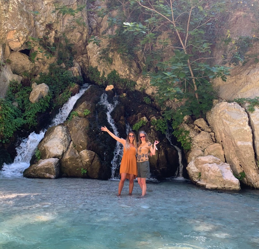 2 ladies standing in front of waterfall in saklikent gorge turkey