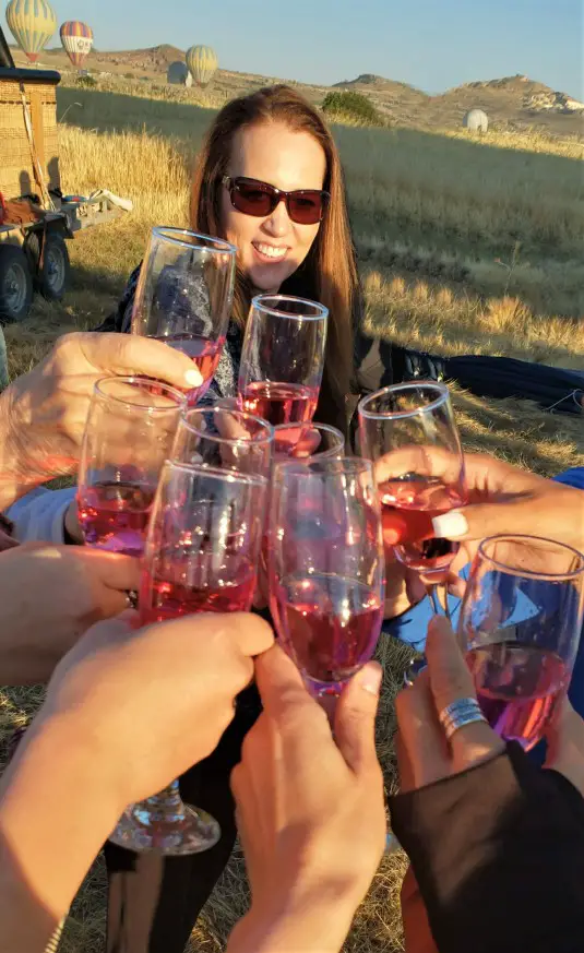 wine glasses toasting the successful landing of a Cappadocia hot air balloon in turkey