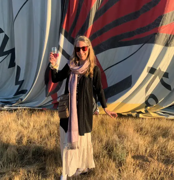 a lady toasting with champagne after a Cappadocia balloon ride in turkey