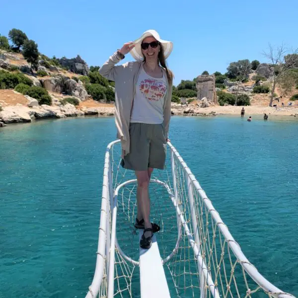 standing on platform of boat over blue water on sunken city boat tour in Kekova Turkey