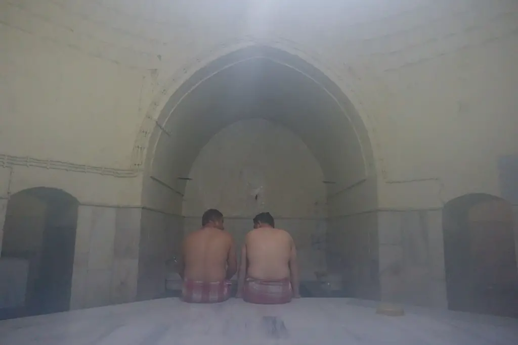 Inside the hammam - 2 men sit in a steam room in Turkey