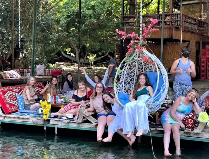 tour group on a lunch stop in Turkey with colorful cushions and swings